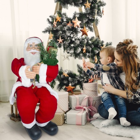 Père Noël assis sur la chaise 90cm 144059 avec sac cadeaux et sons de décoration